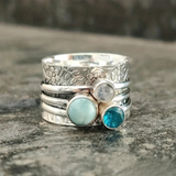 Handcrafted Floral Silver Spinner Ring with Blue Gemstones
